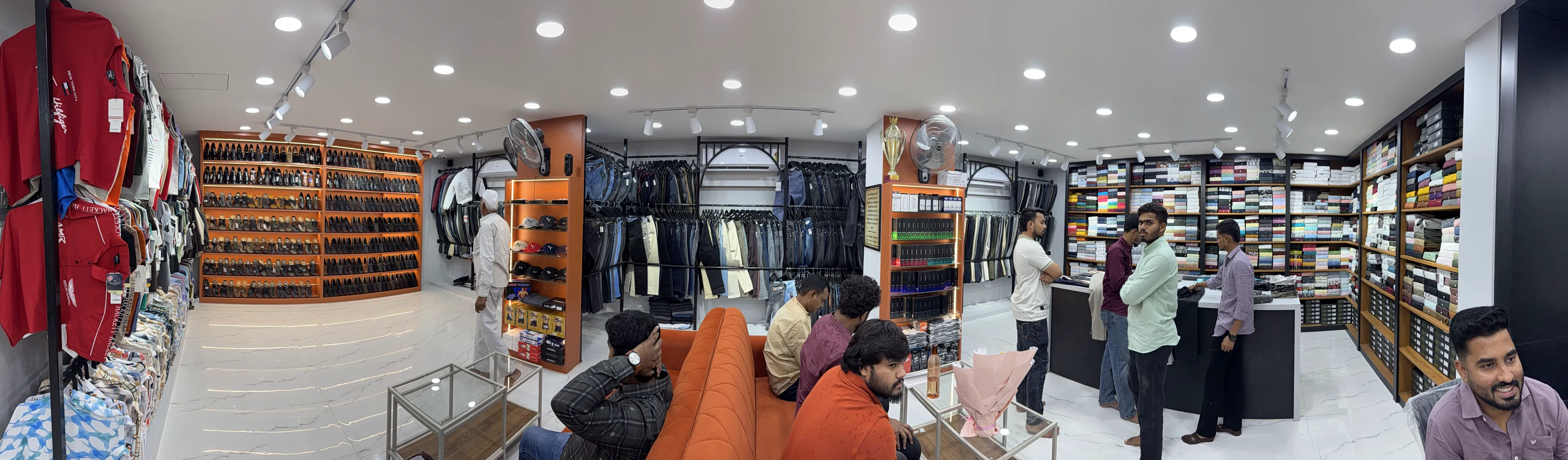 Panoramic view of customers and team members inside a Maaax apparel store